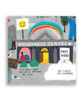 Close-up section of the City of Gratitude map featuring the “Kindness Centre” building with a rainbow, “Free Hugs” sign and the phrase “In a world where you can be anything, be kind.”