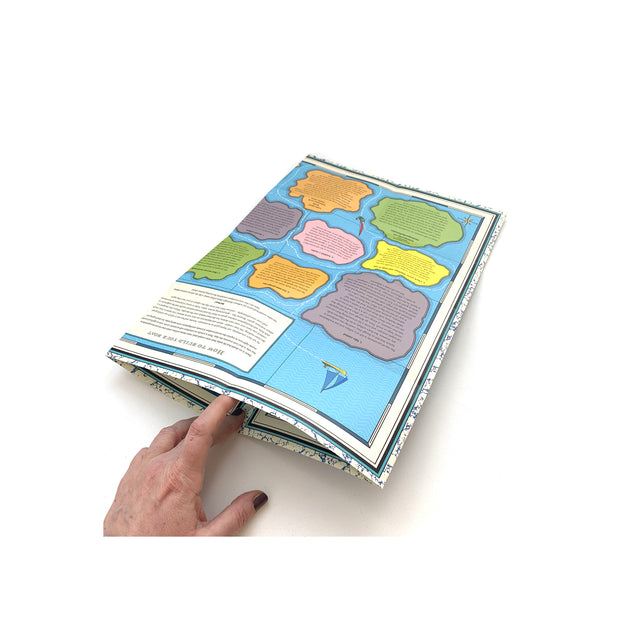 Folded Mapology Guide The Sea of Uncertainty held by hand, showing part of the illustrated islands